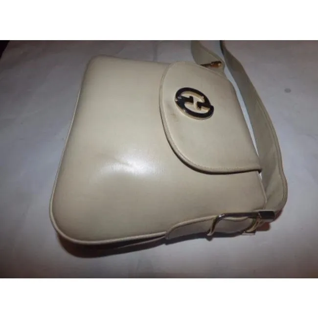 Vintage mod, Gucci, ivory leather 1973 shoulder bag with a gold GG flap snap closure & lots of room
